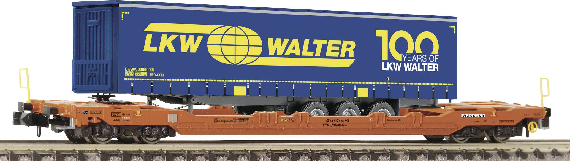 An orange freight train wagon is transporting a blue container with a yellow 'LKW Walter' logo and '100 Years' text.