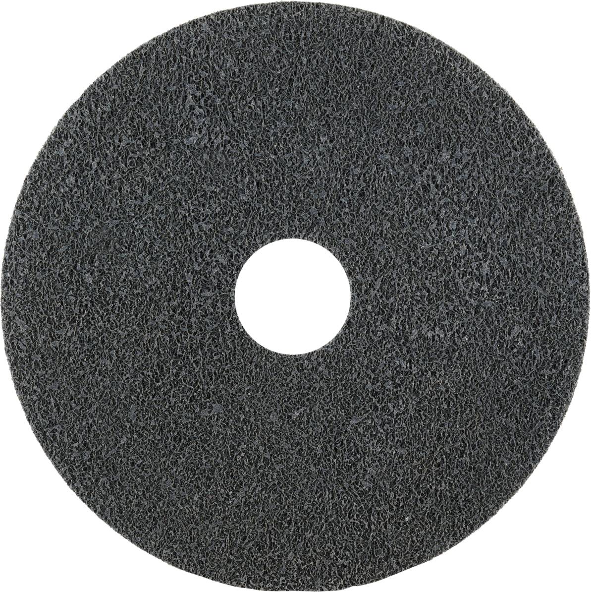 Grey grinding wheel with a rough texture and central hole, used for grinding work on various surfaces.
