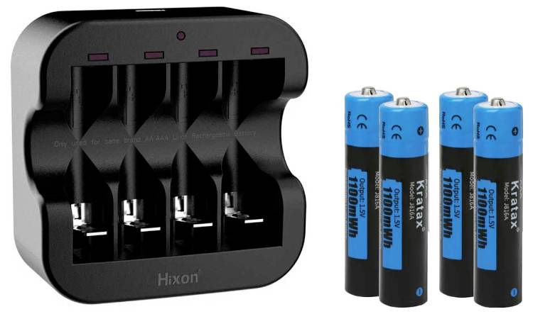 A black charger with four slots and four blue-black AA batteries beside it.