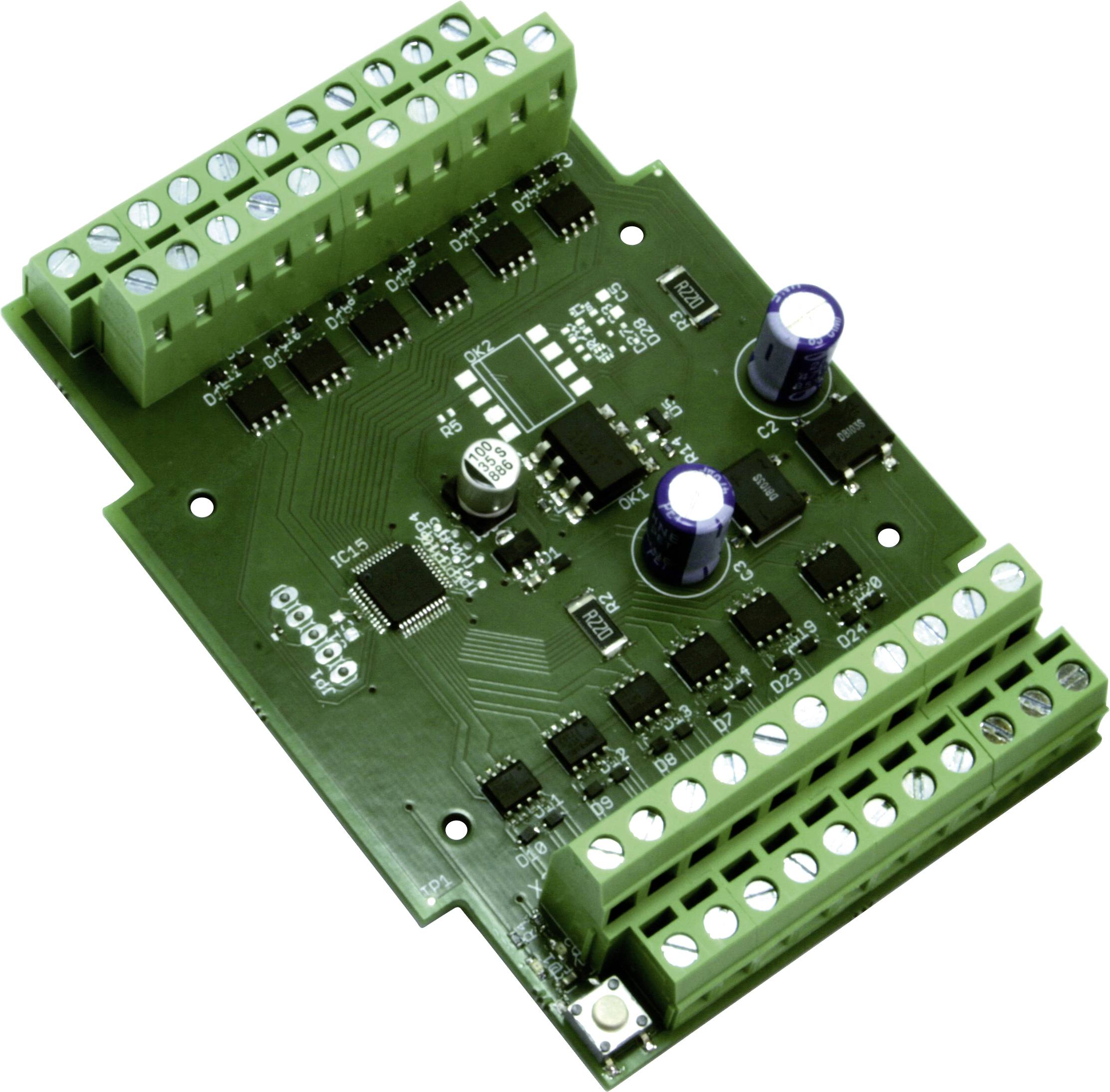 A green printed circuit board filled with electronic components, including capacitors and terminals for connections.