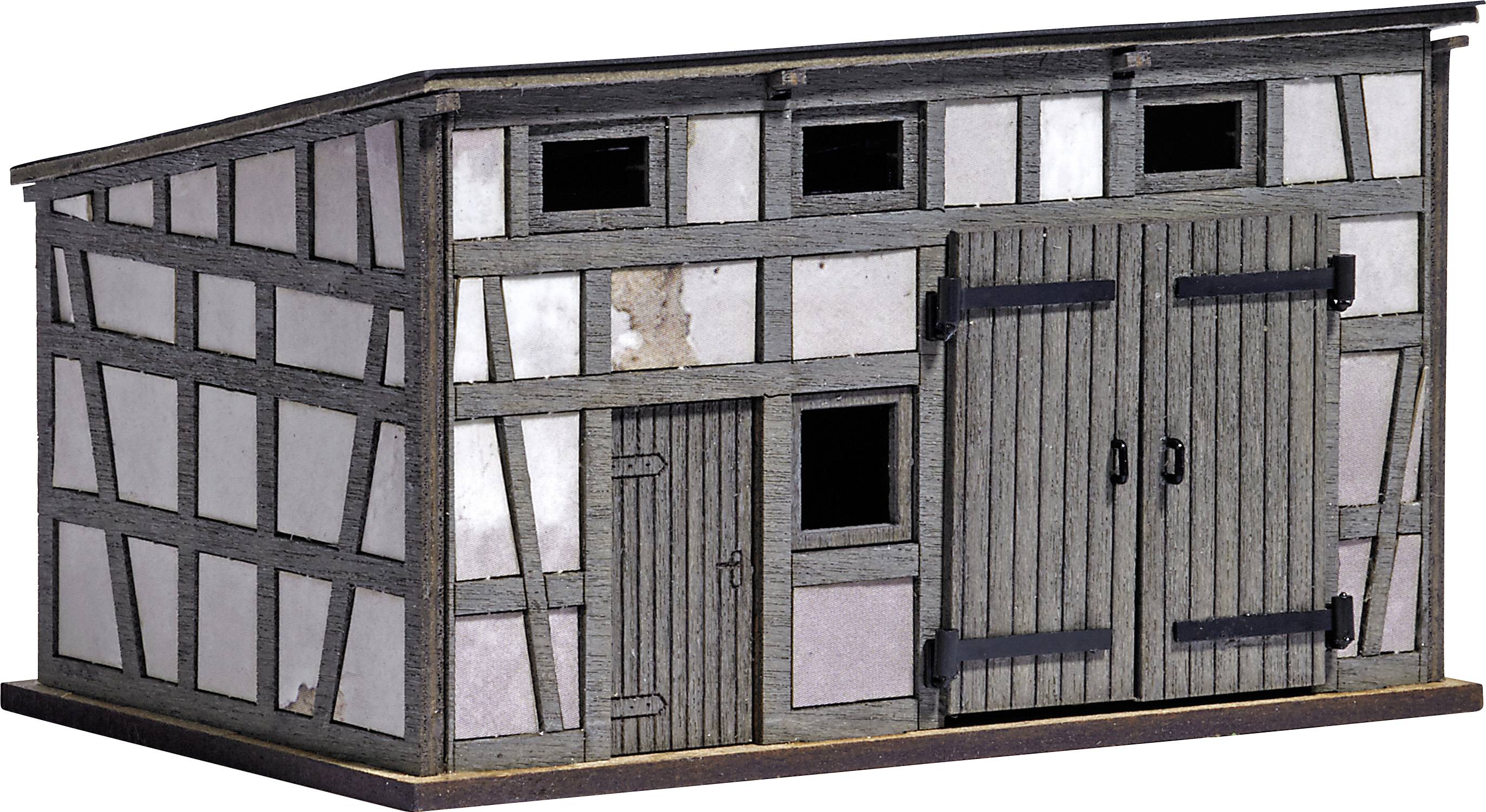 Small wooden model building with sliding doors and windows, designed in a half-timbered style.