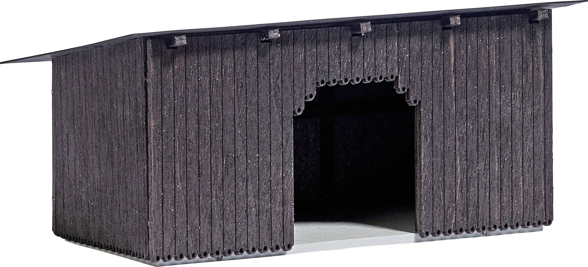A small, dark wooden barn with a large archway in the middle.