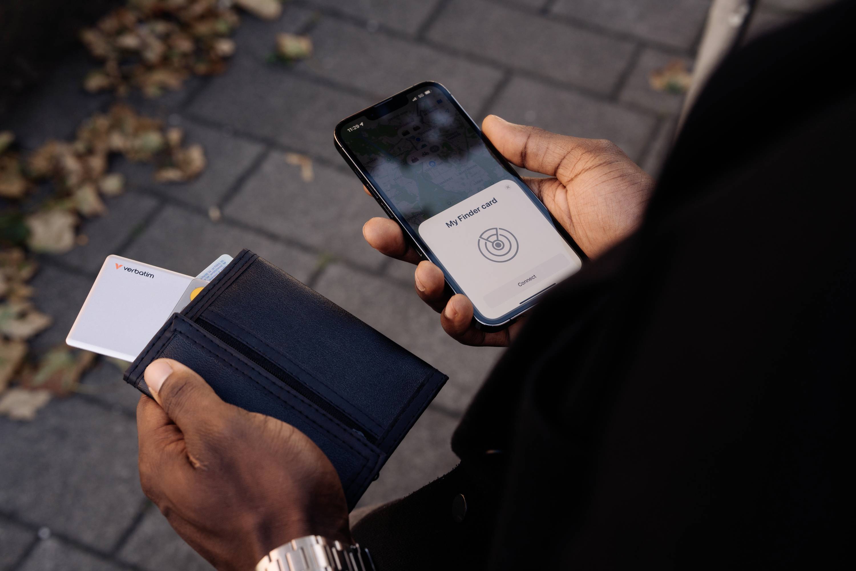 A person is holding a smartphone and an open wallet. An NFC payment is displayed on the smartphone.