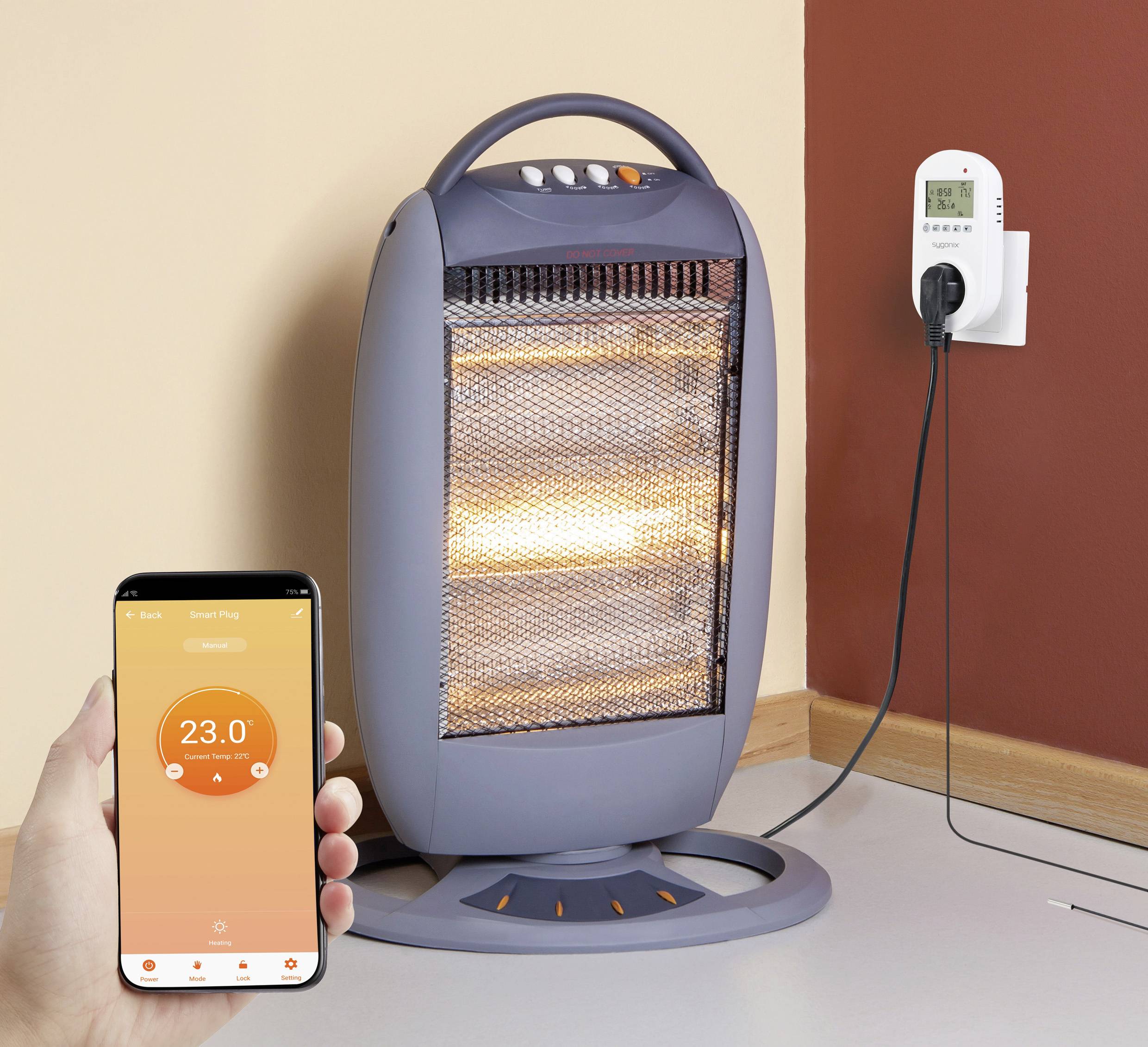 An electric heater stands in a corner. A hand holds a smartphone displaying a temperature of 23.0 degrees in an app.