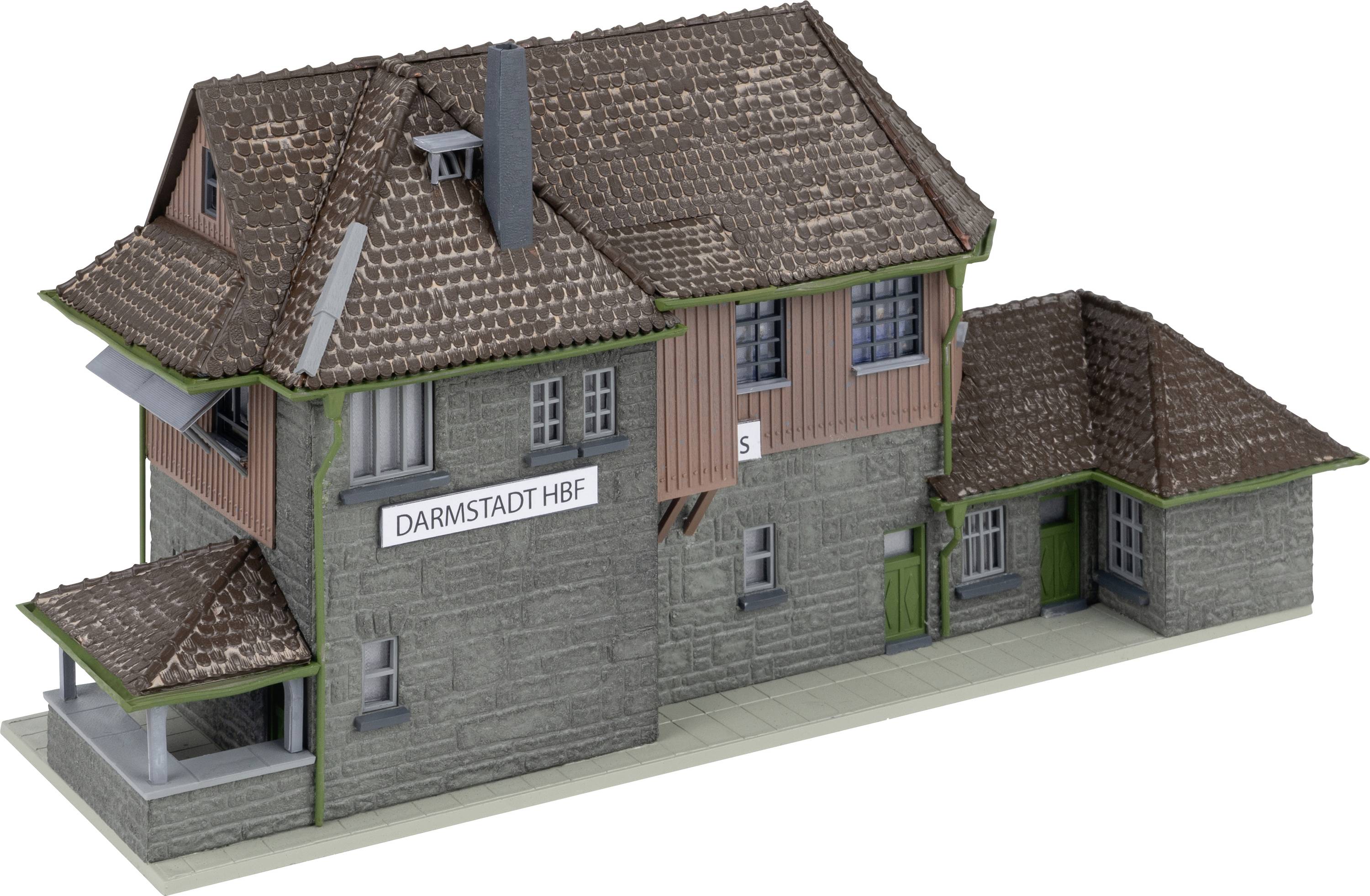 A model building of a railway station with the inscription 'Darmstadt Hbf'. It has a detailed tiled roof and green window shutters.