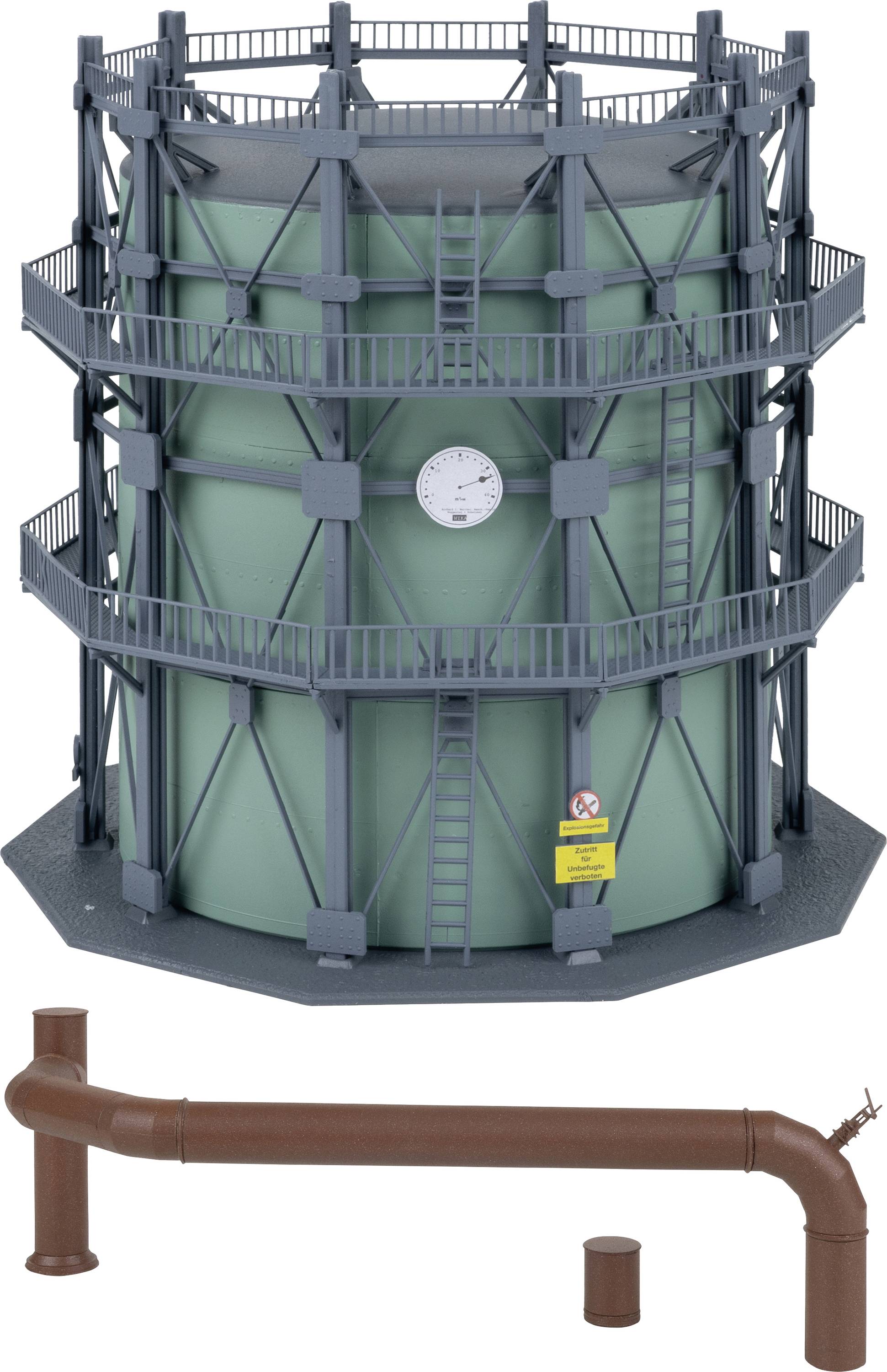 Industrial Plant: Large circular container with stairs and railings, green wall with clock. Brown piping system in the foreground.