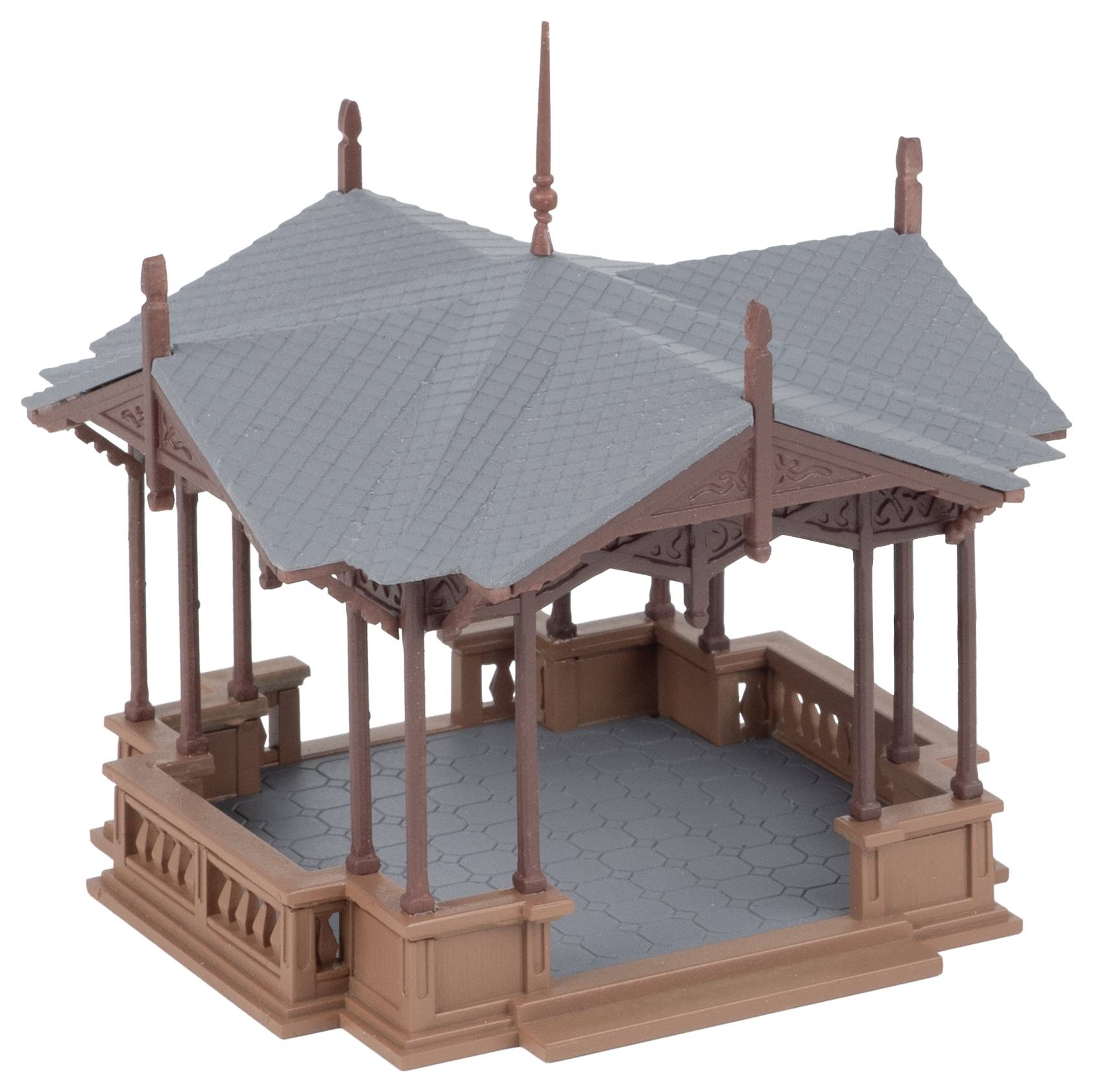 A brown model pavilion in the Victorian style with a grey roof and decorative details stands on a tiled platform.