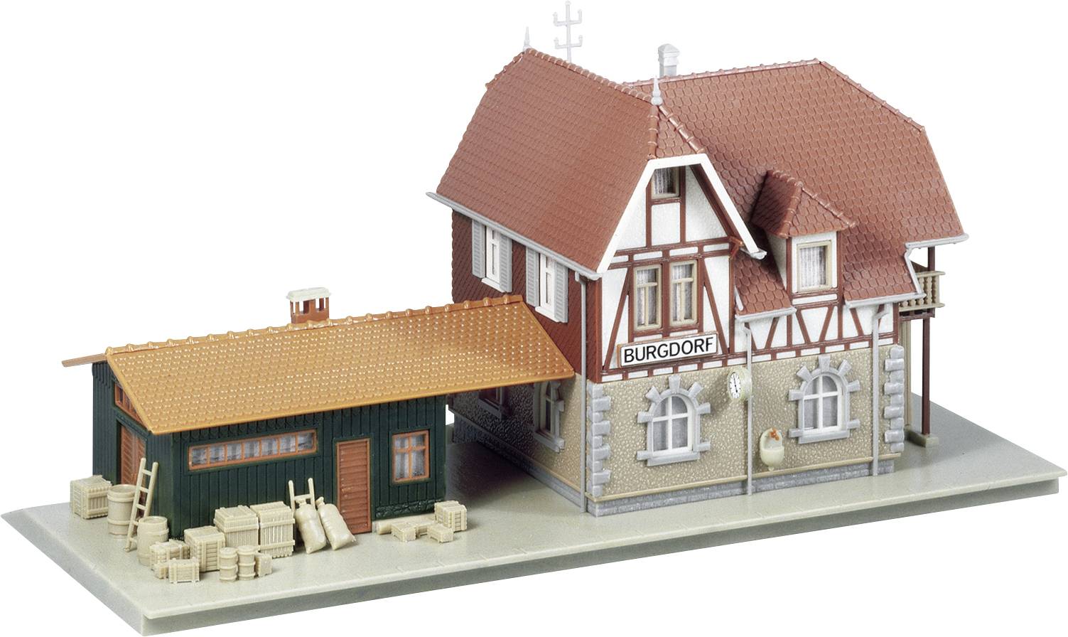 Miniature model of a half-timbered house with a red roof and adjacent shed. A sign reading 'Burgdorf' is visible.