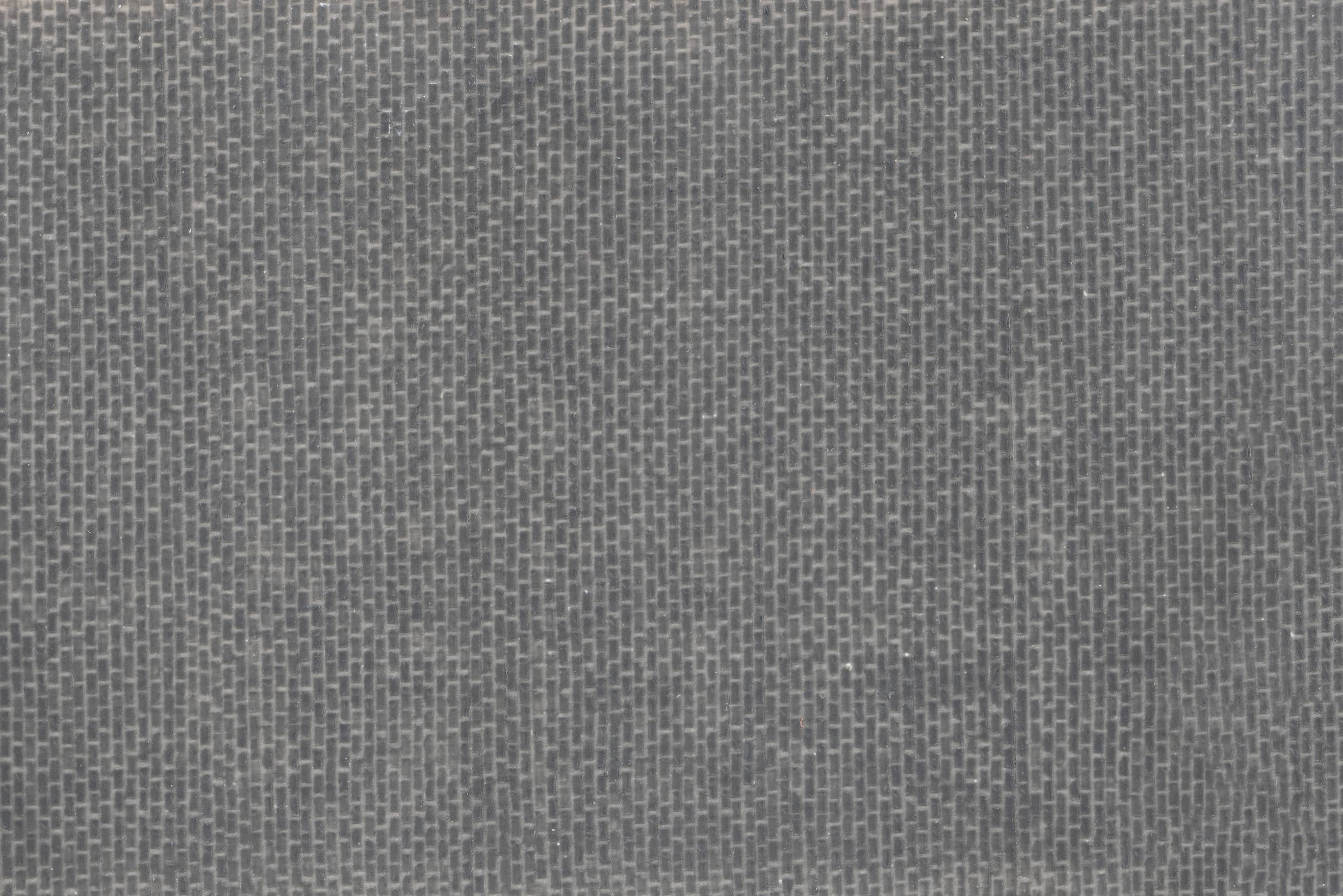 Close-up of a navy blue fabric with a woven pattern of fine, intersecting threads.