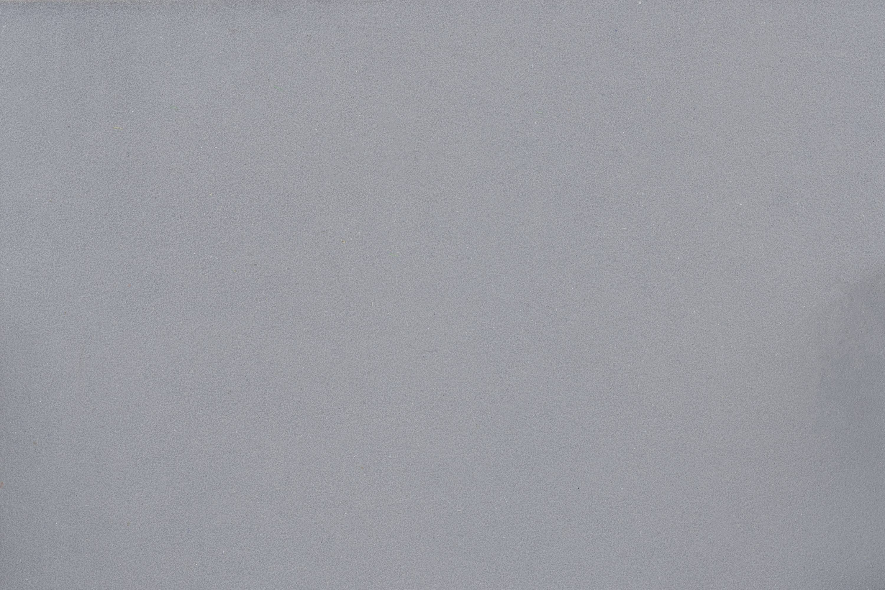A single-coloured grey surface, possibly a wall or a background without distinctive features or details.