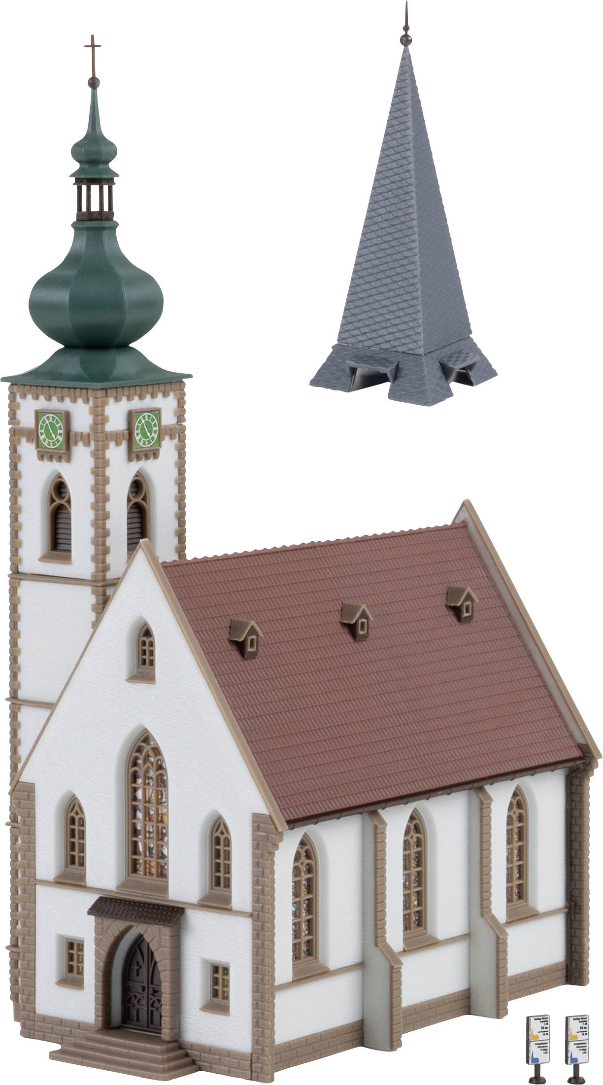 A model of a church with a green tower and a separate grey bell tower, light-coloured walls, and a brown roof.