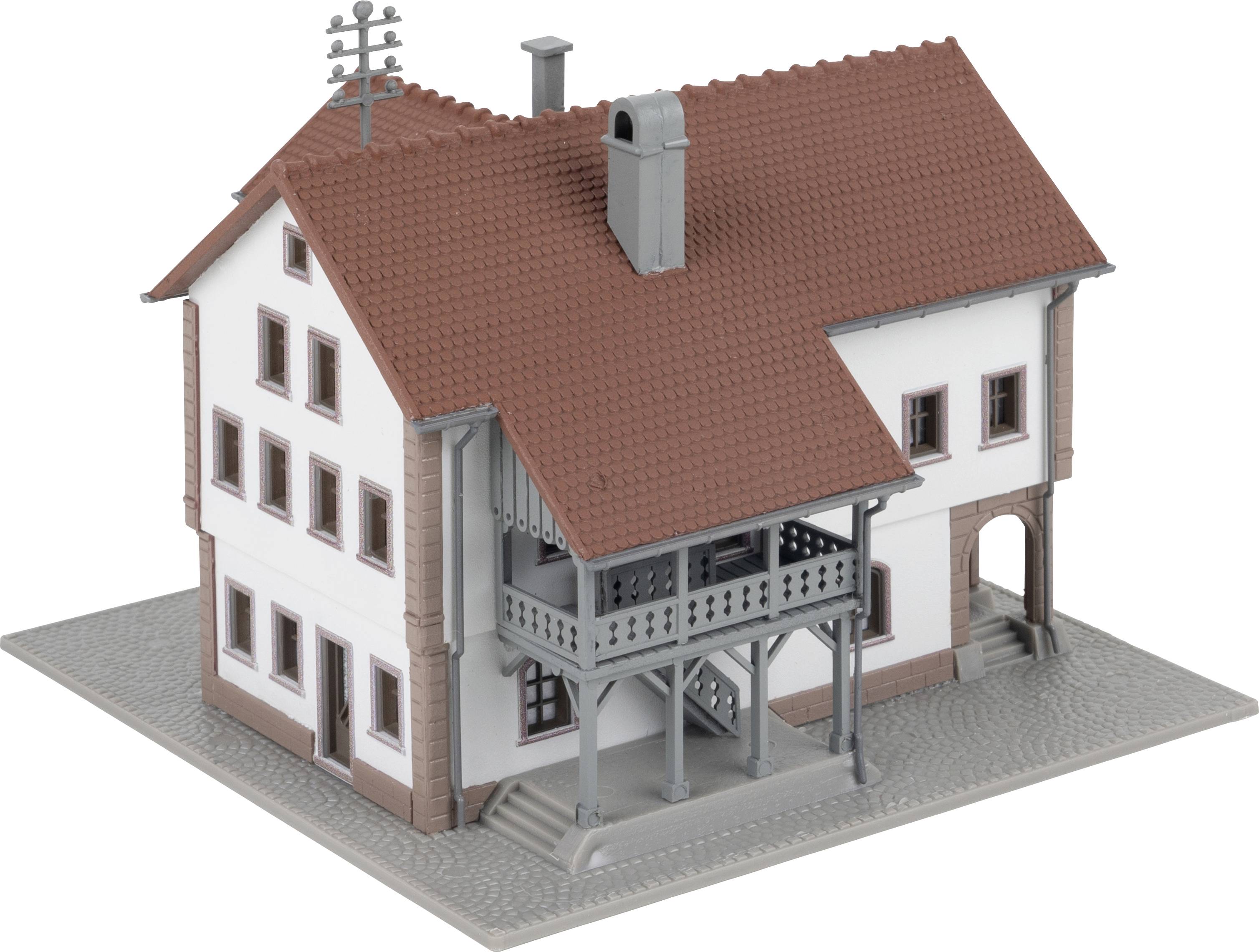 A model house with a red roof and white façade, which has two storeys. It comprises an entrance area with an external staircase.