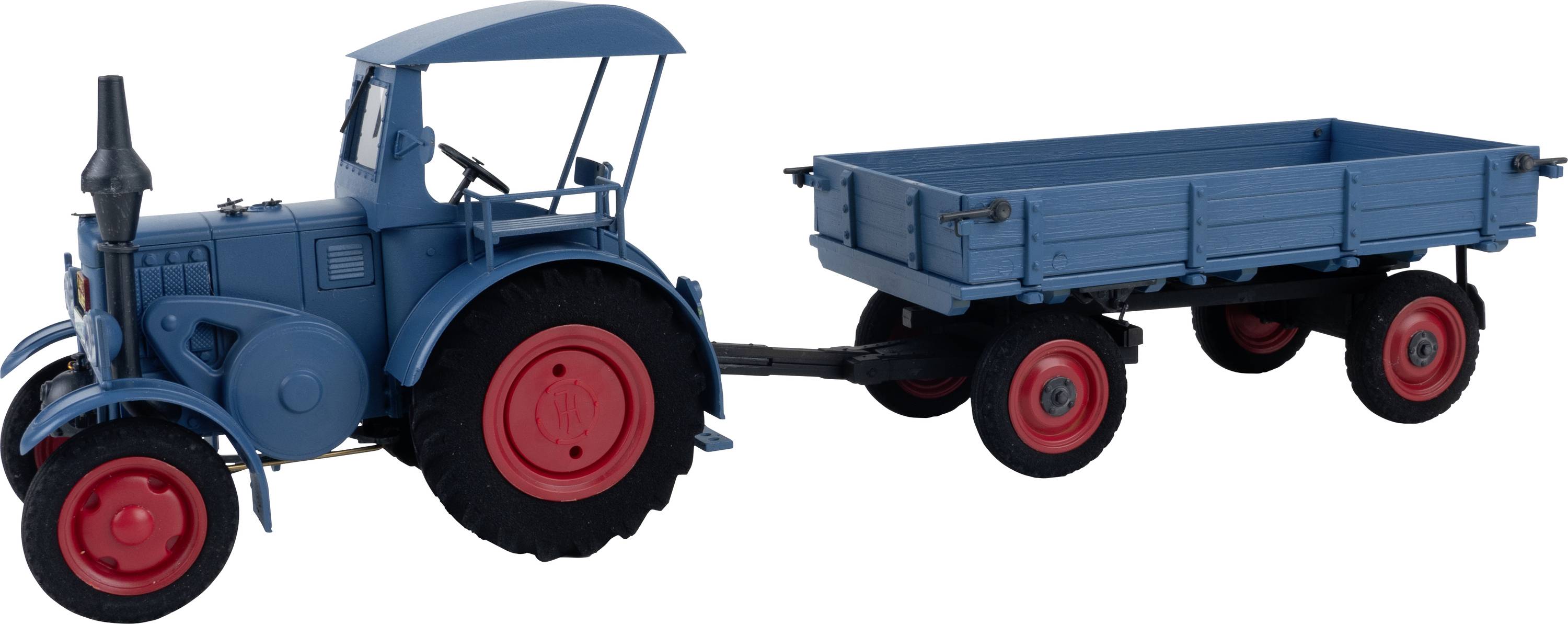 A blue tractor with red wheels is pulling a trailer. The trailer has a higher box-like body and also has red wheels.