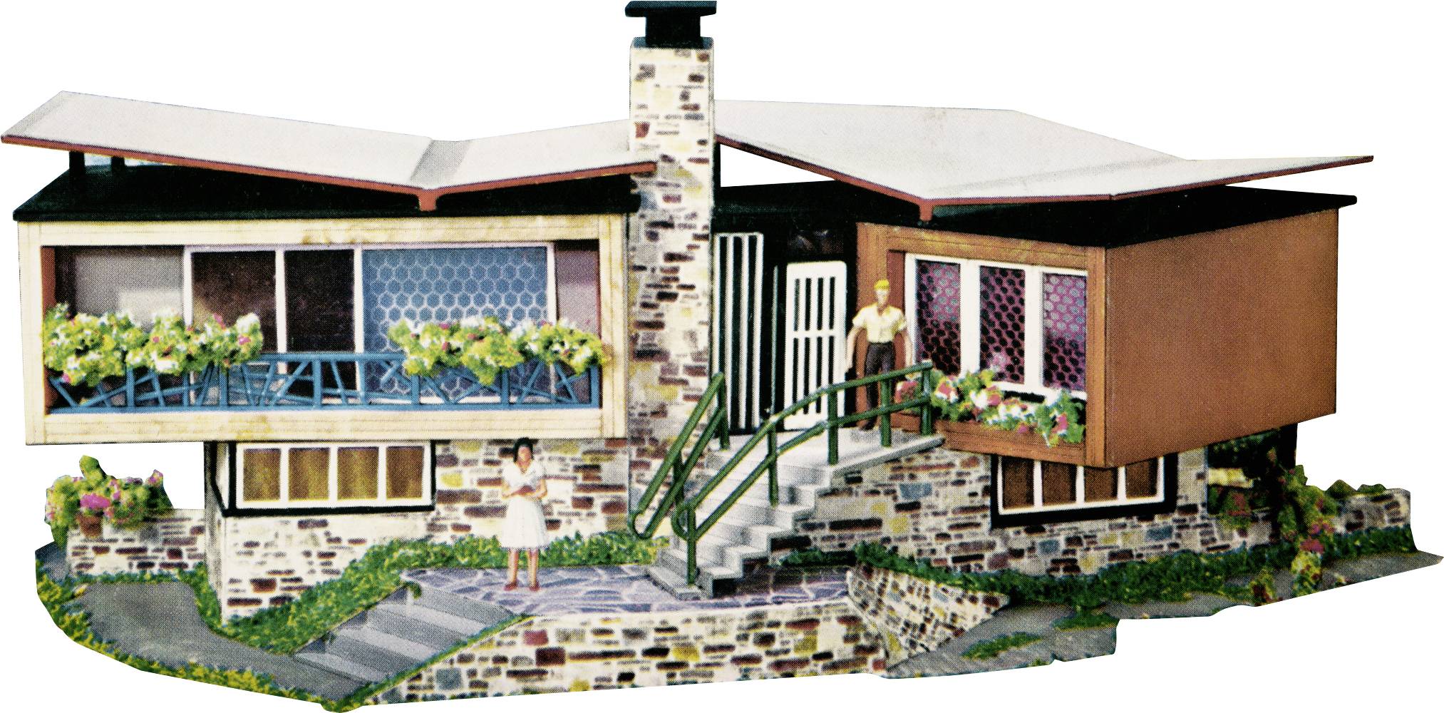 A model house in a classic architectural style with a stone entrance and steps. Two figures are standing on the terrace and at the entrance.