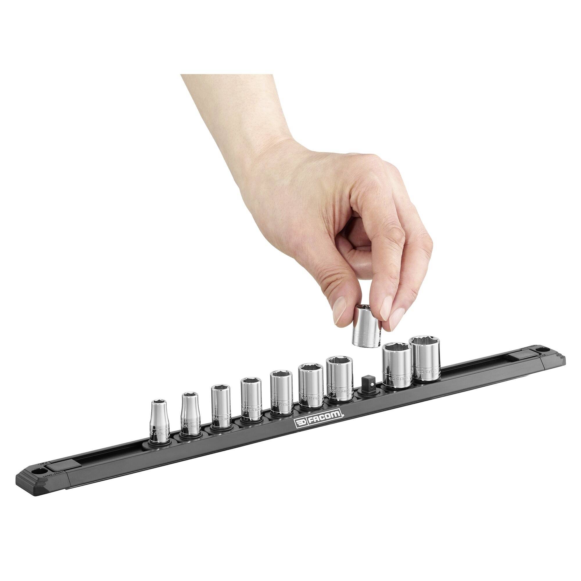 A hand reaches for a socket from a socket wrench set on a black holder.