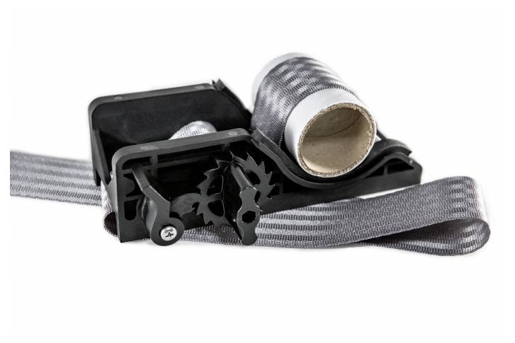 A black device with a roll of grey fabric tape, ready for stretching or securing.