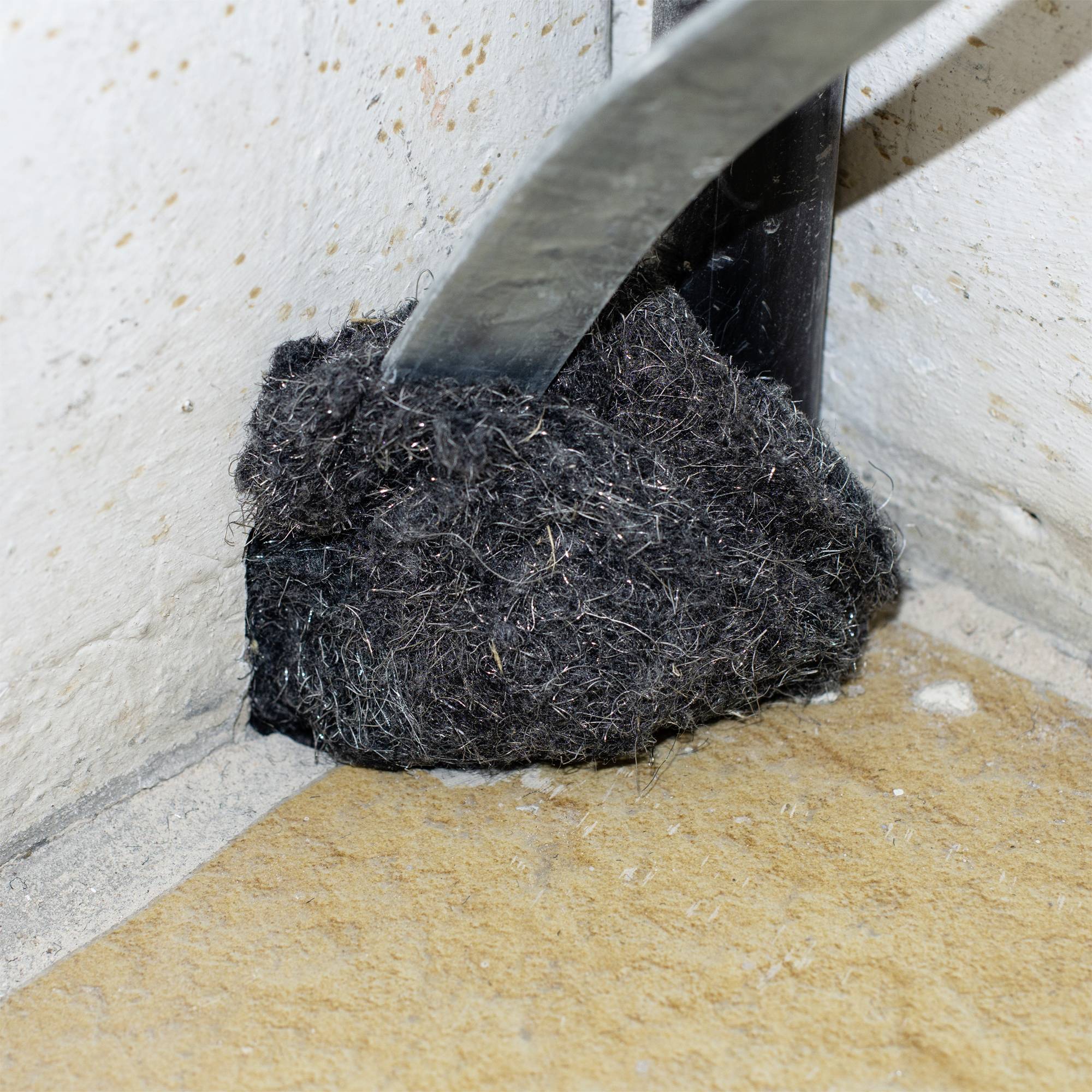 Steel wool wrapped around a pipe, presumably to prevent small animals or dirt from entering.