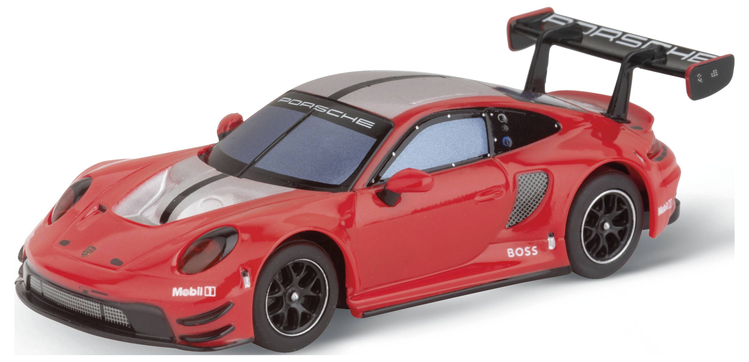 Red model car of a sports car with black rear spoiler and visible markings. The toy stands on a white surface.