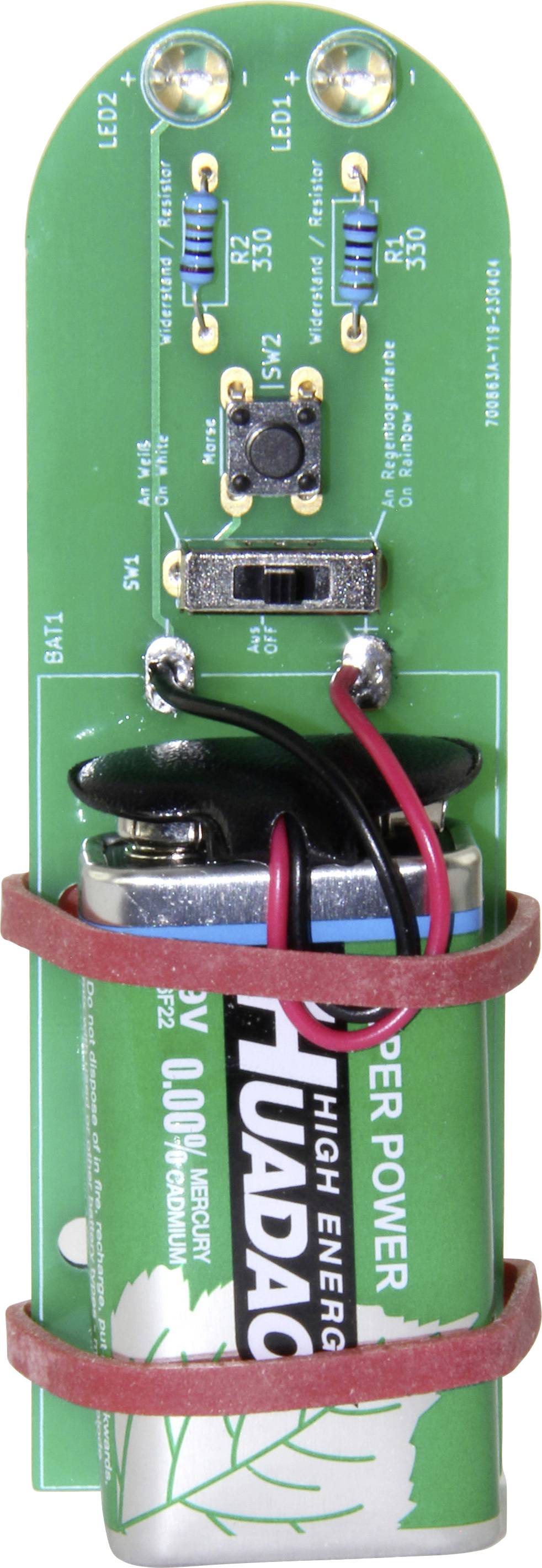 Green printed circuit board with a mounted battery, electronic components, and connections; shows a small circuit unit.