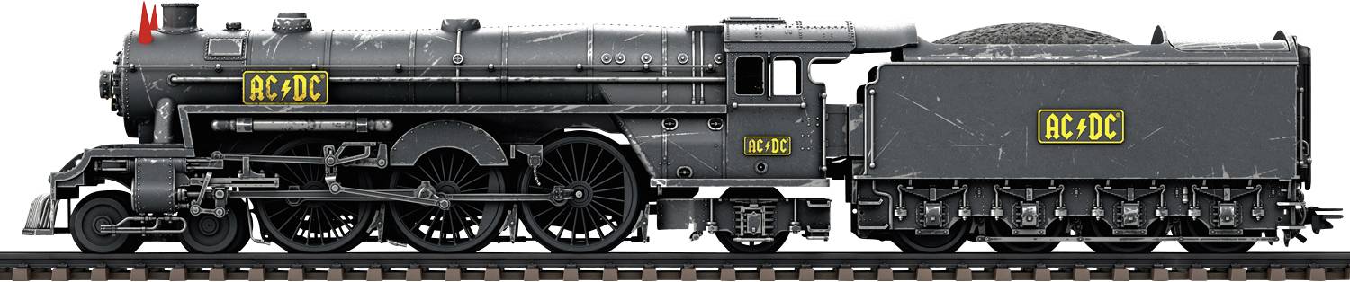Black steam locomotive in a retro style with yellow 'AC-DC' lettering on the cab and tender, standing on railway tracks.