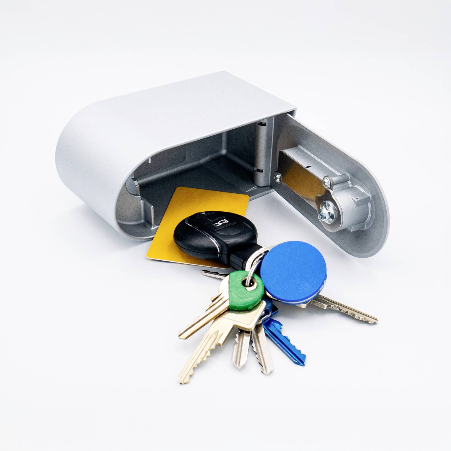 A metal key cabinet with an open front, containing a set of five different keys and two coloured key tags.