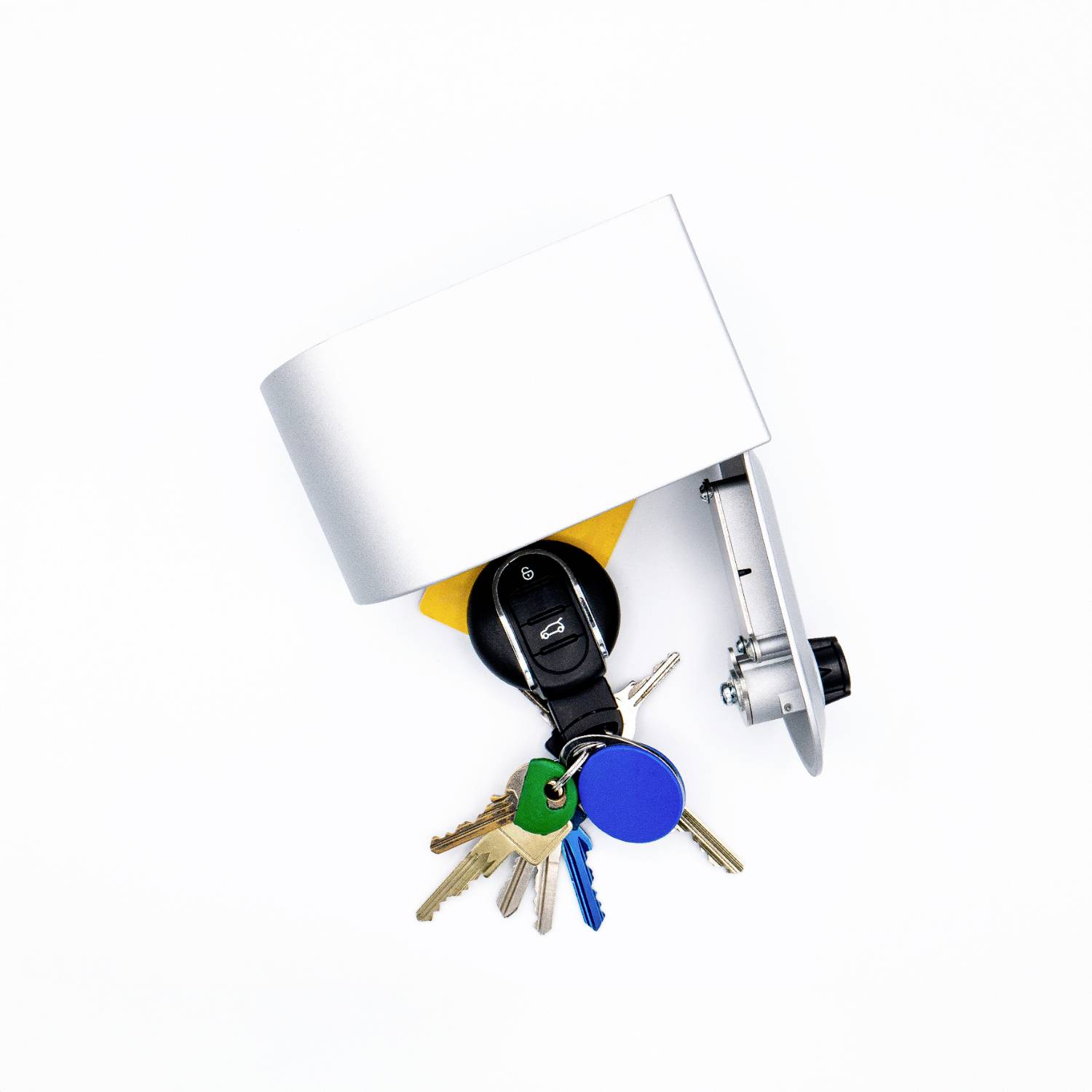 A bunch of keys with several metal and plastic keys, including a car key fob, hanging on a metallic holder.