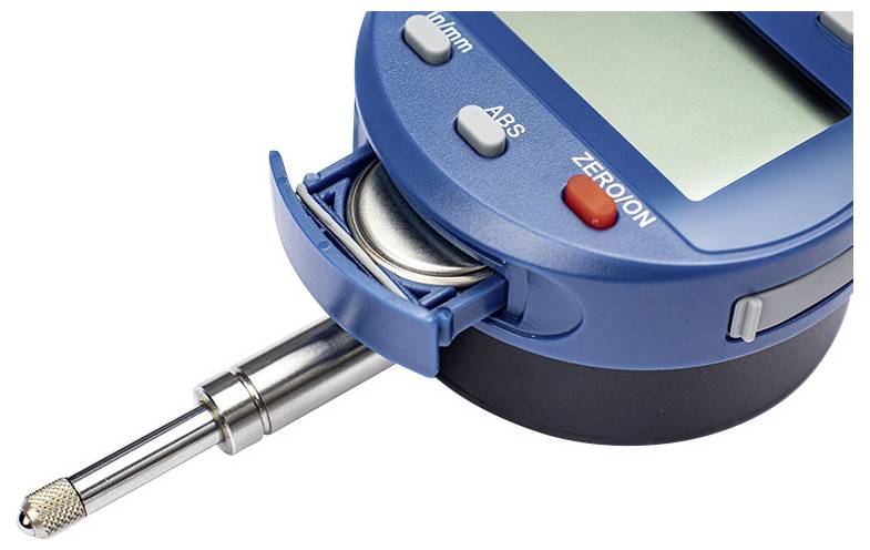 A digital measuring instrument with a metal probe, buttons labeled 'On/Off', 'ABS', and 'Zero'. A battery is partially ejected.