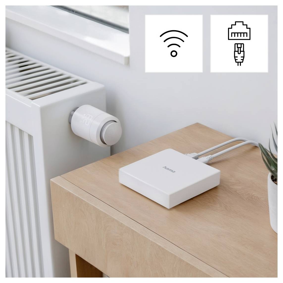 A smart device connects to both a radiator and a network cable on a wooden desk. Icons above show Wi-Fi and Ethernet connectivity options.