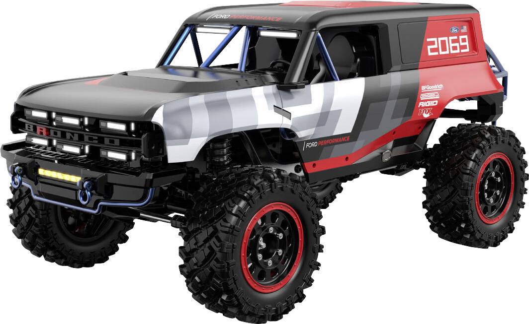 A red, black, and white off-road vehicle toy with oversized tires and '2069' on the side, showcasing a rugged, futuristic design.