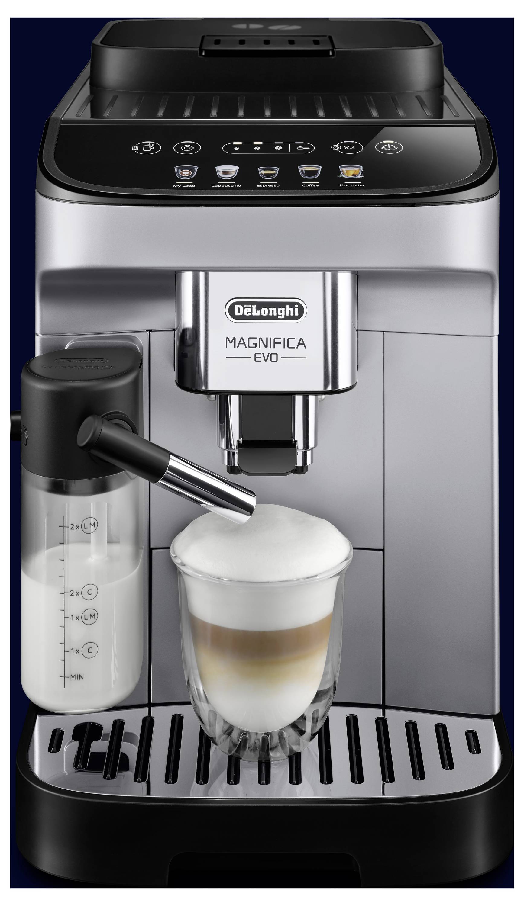 A De'Longhi Magnifica Evo coffee machine dispensing a cup of cappuccino with foam into a glass, alongside a milk frothing container.