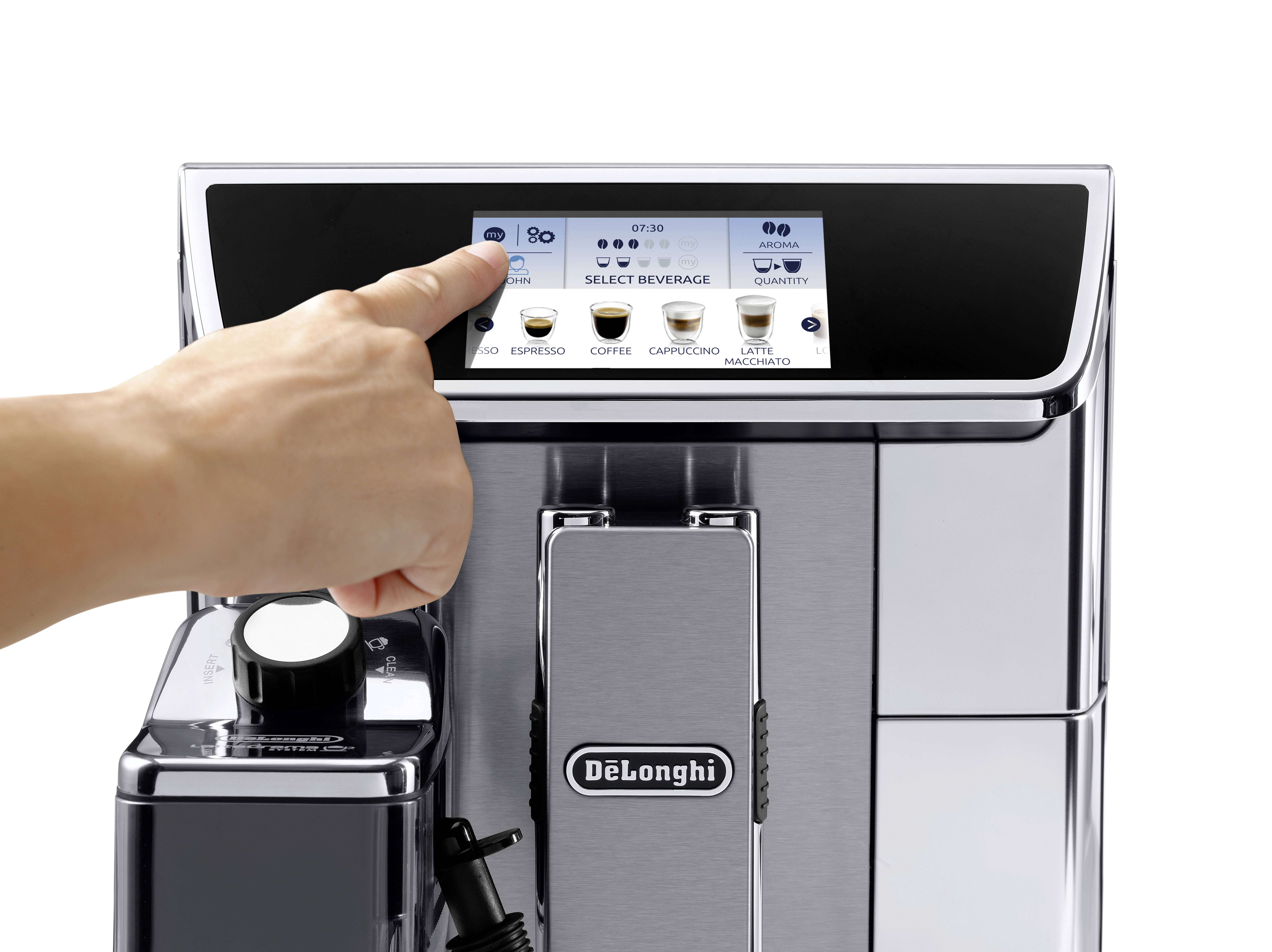 A hand selects options on a DeLonghi coffee machine touchscreen with choices like 'Espresso' and 'Cappuccino.'