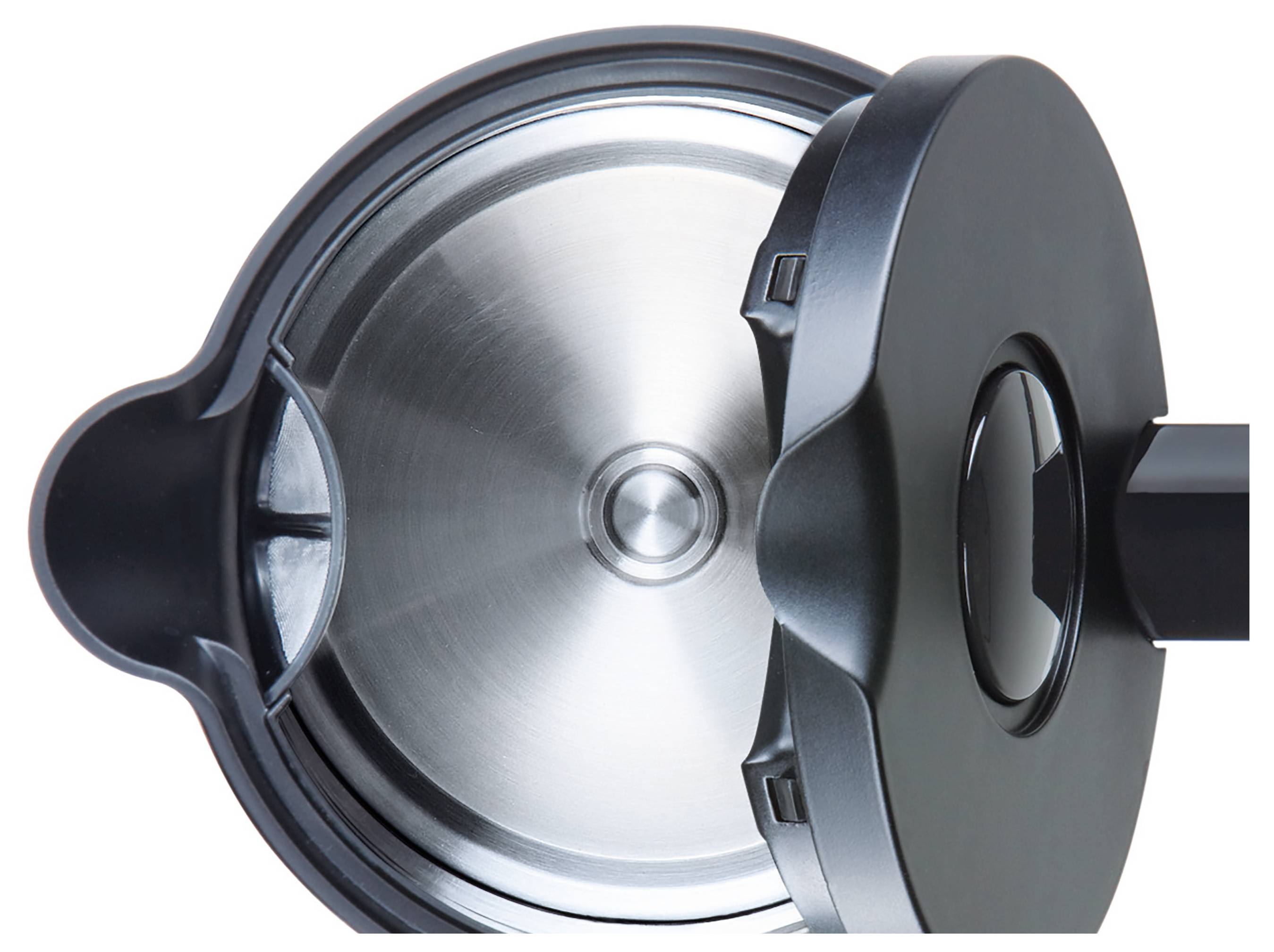 A close-up of a pressure cooker lid, showing the circular metal interior and dark handle, positioned against a white background.