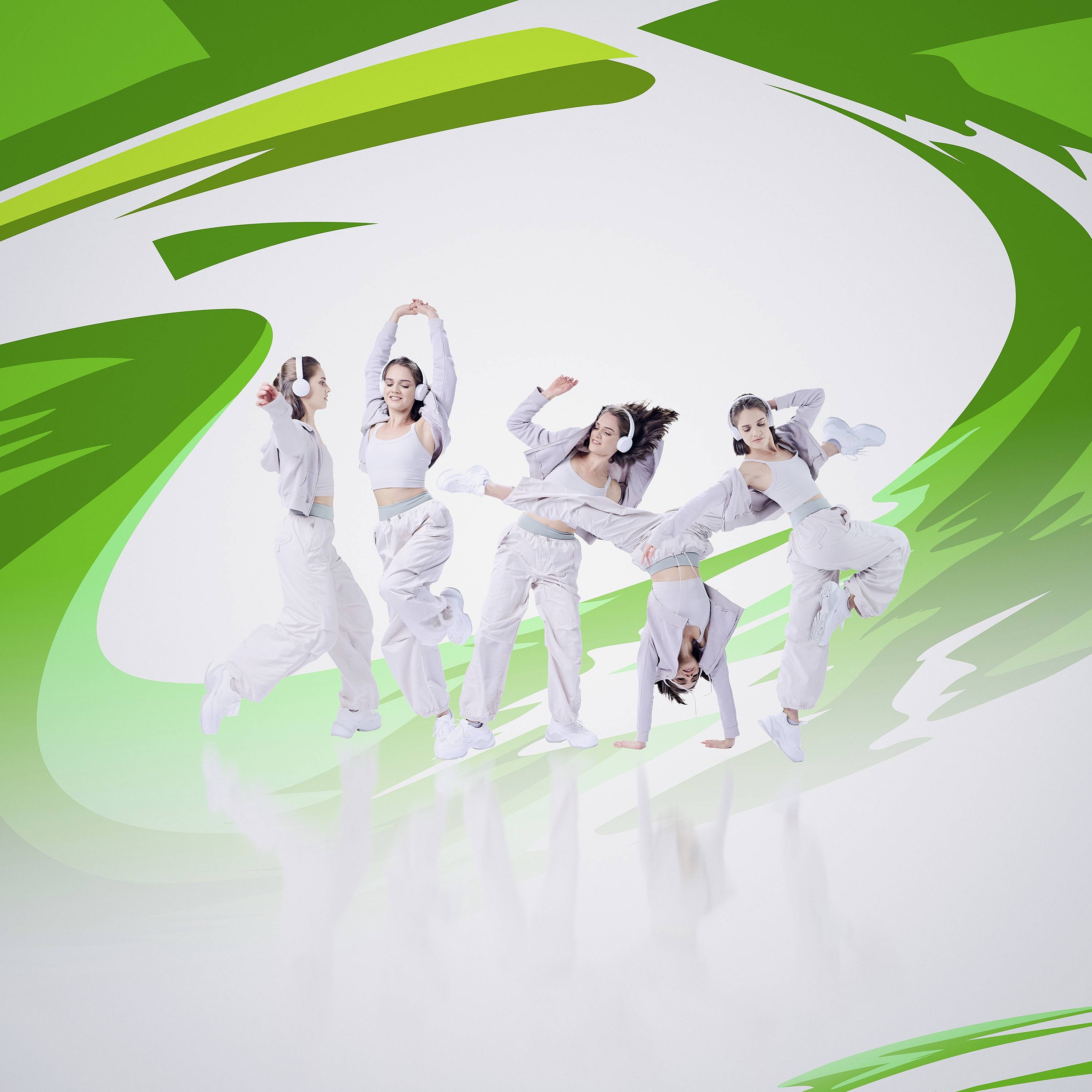 Dancers in white attire perform dynamic moves against a green and white abstract background, conveying energy and fluidity.