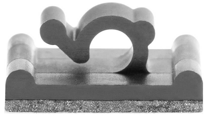 A metal clamp with a curved top and flat base, used for securing cables or wires, placed on a light surface.