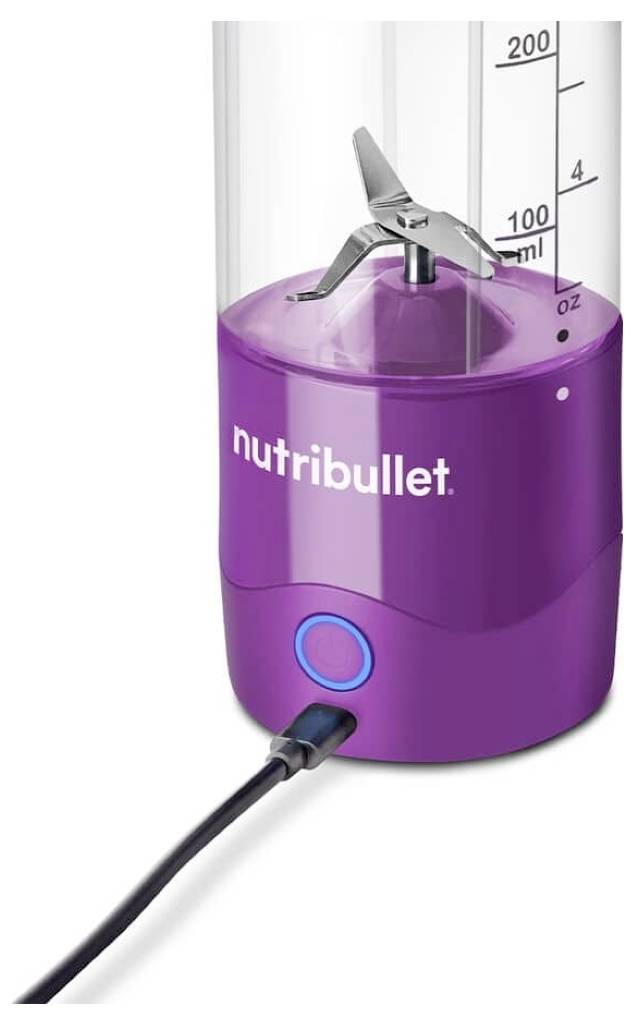 Portable blender with a purple base, labeled 'nutribullet,' and a transparent blending container with measurement markings.