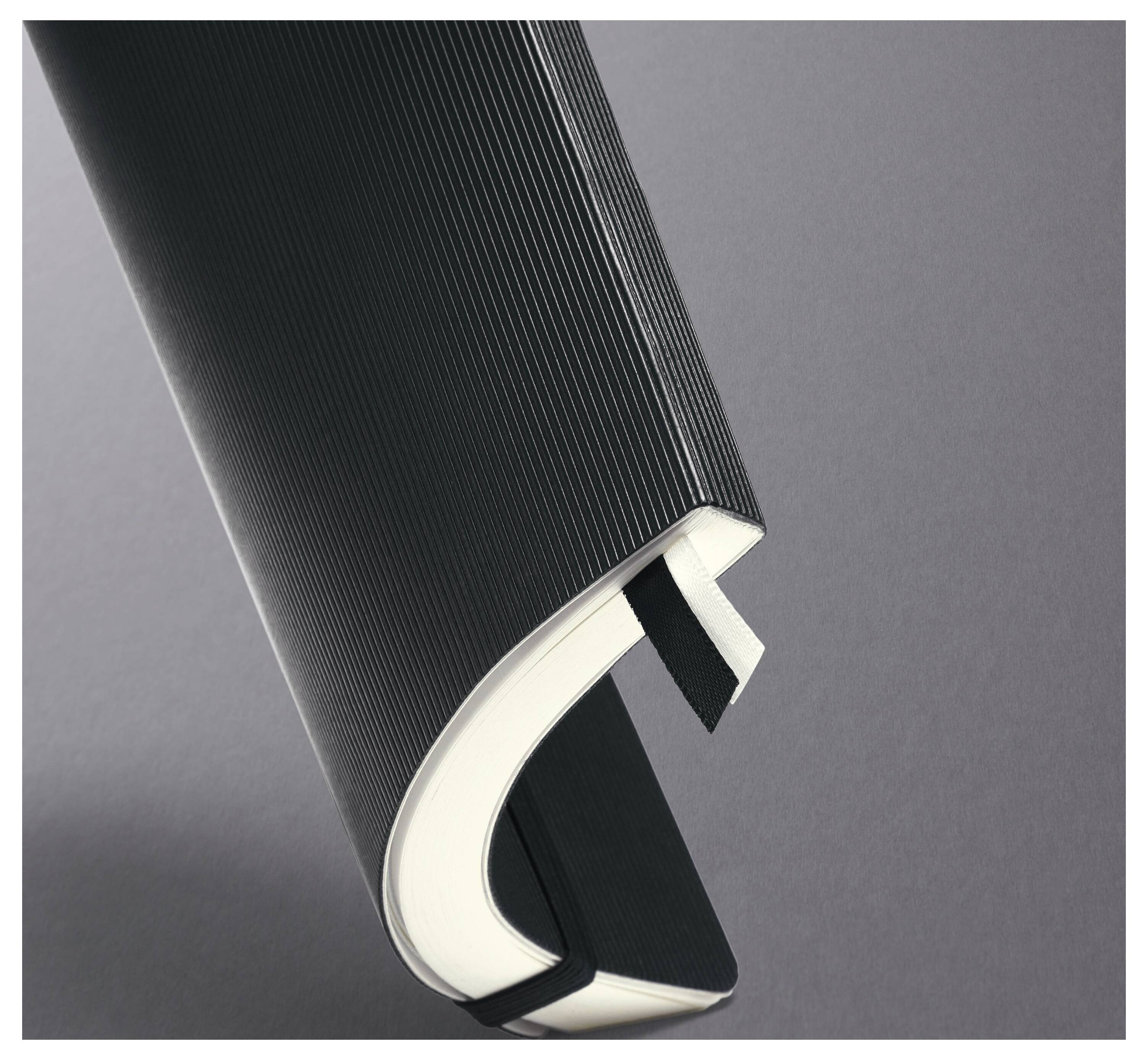 A curved, partially open book with a black textured cover and white pages is shown against a gray background.