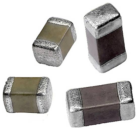 Four small, rectangular electronic components with metallic ends, possibly capacitors or inductors, vary in color between light and dark shades.