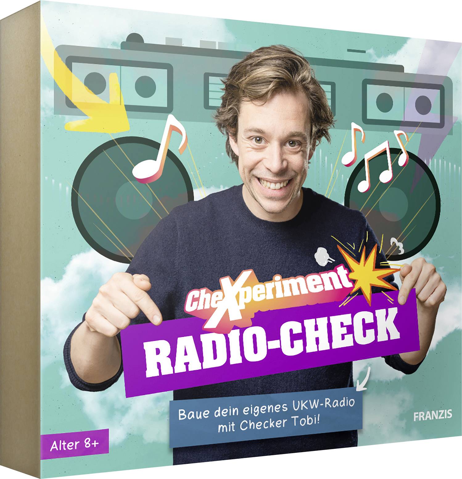 A person smiling and pointing to a colorful box labeled 'Experiment Radio-Check', suggesting a DIY radio kit for ages 8 and up.