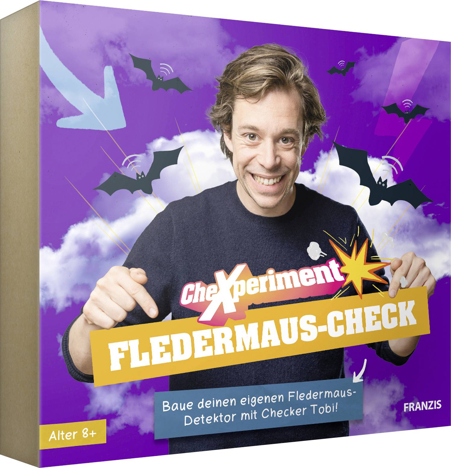 'A smiling person points to a bat-themed science kit box titled 