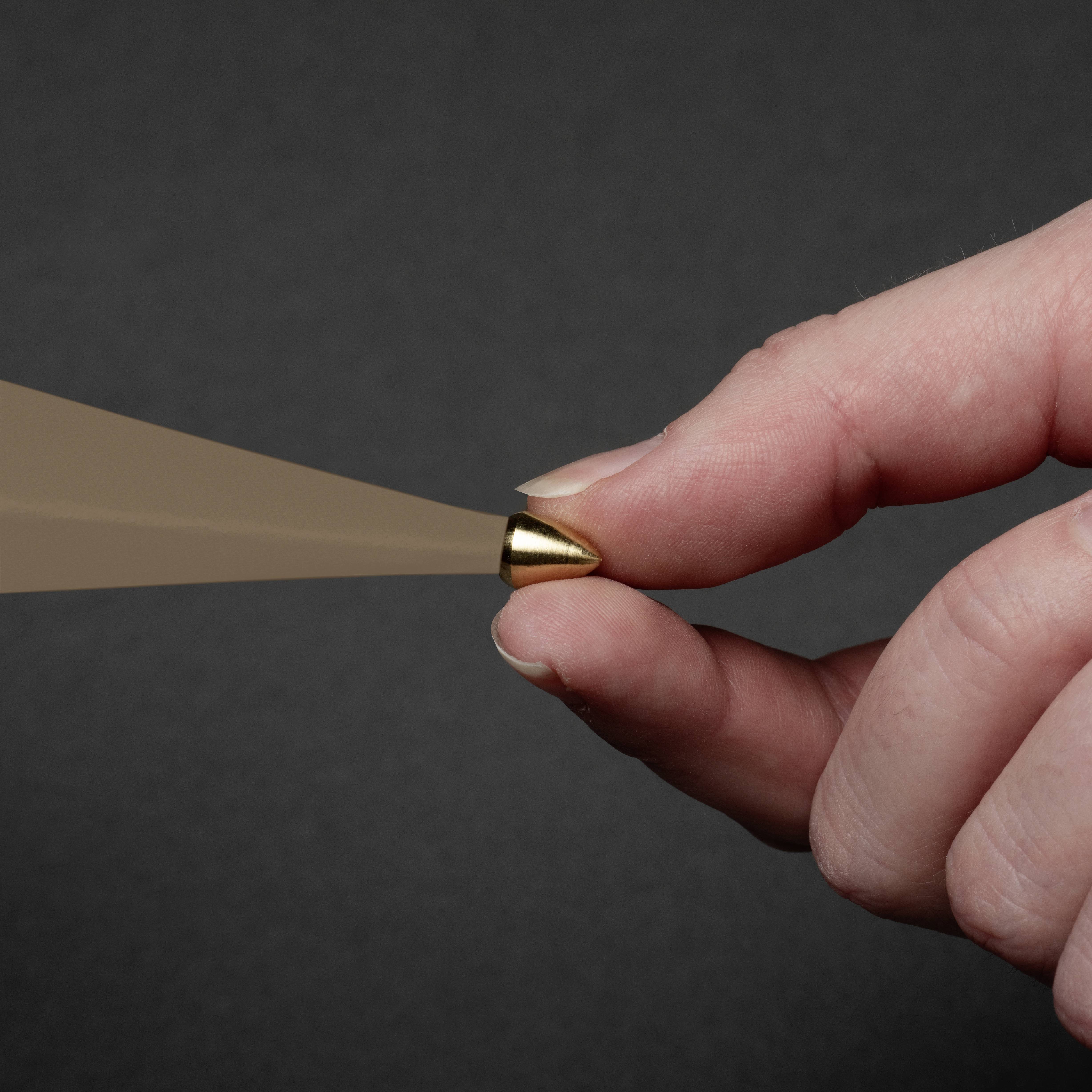 A hand holds a sharpened pencil, angled downward, ready to write or draw against a dark background.