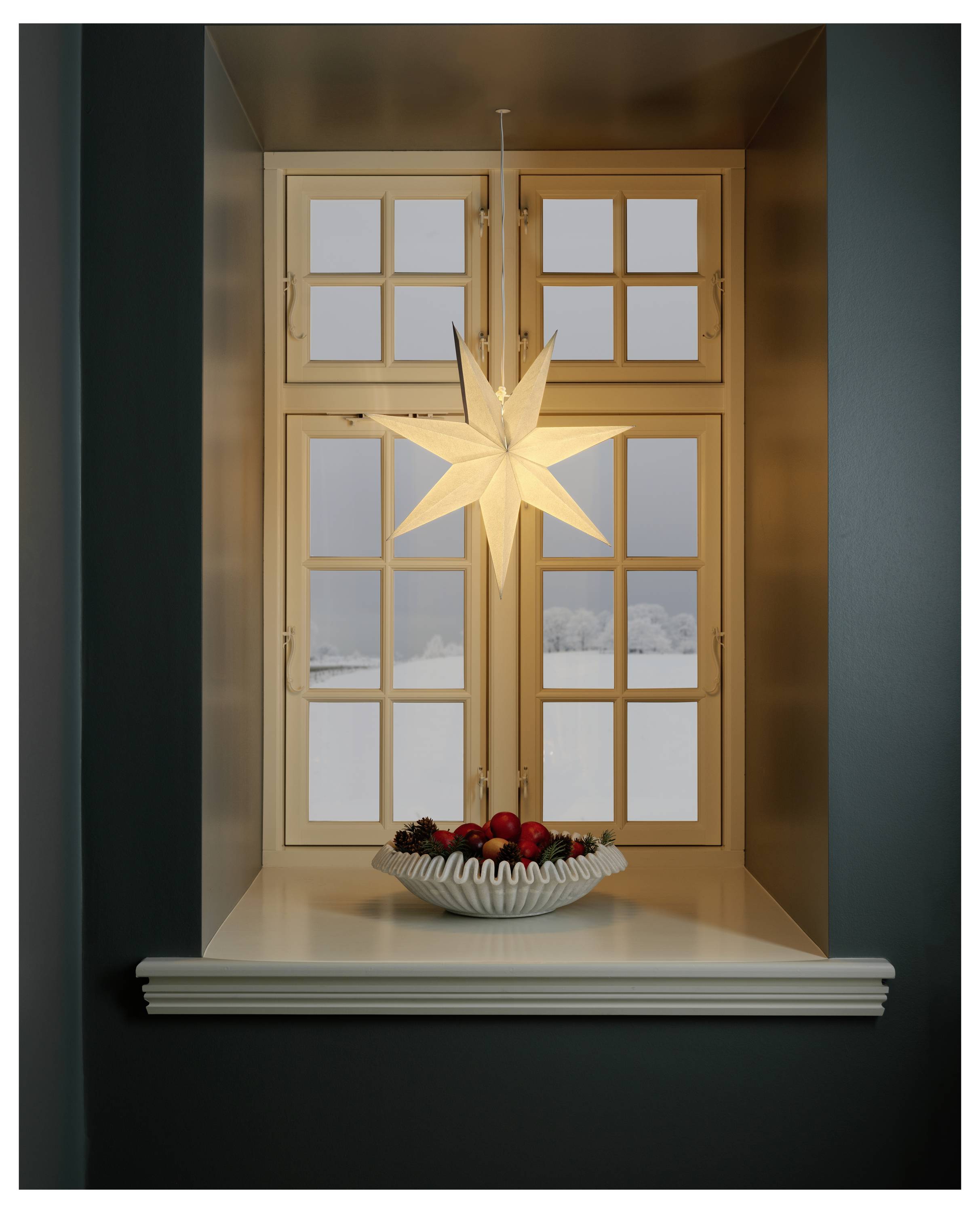 A close-up of a brown pencil with a sharp, gold-colored tip against a dark background.