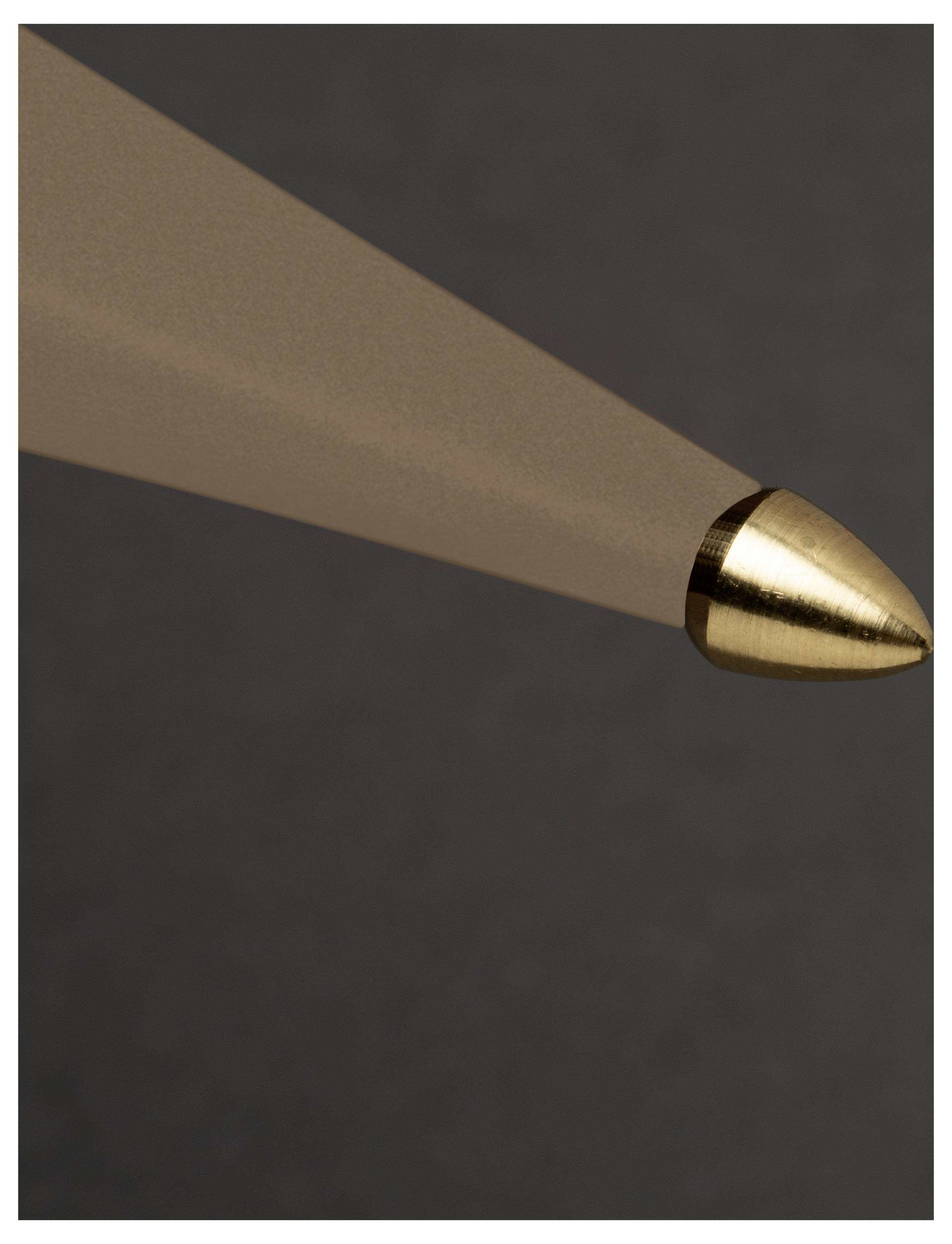 A close-up of a brown pencil tip with a gold-colored metal casing against a dark background.