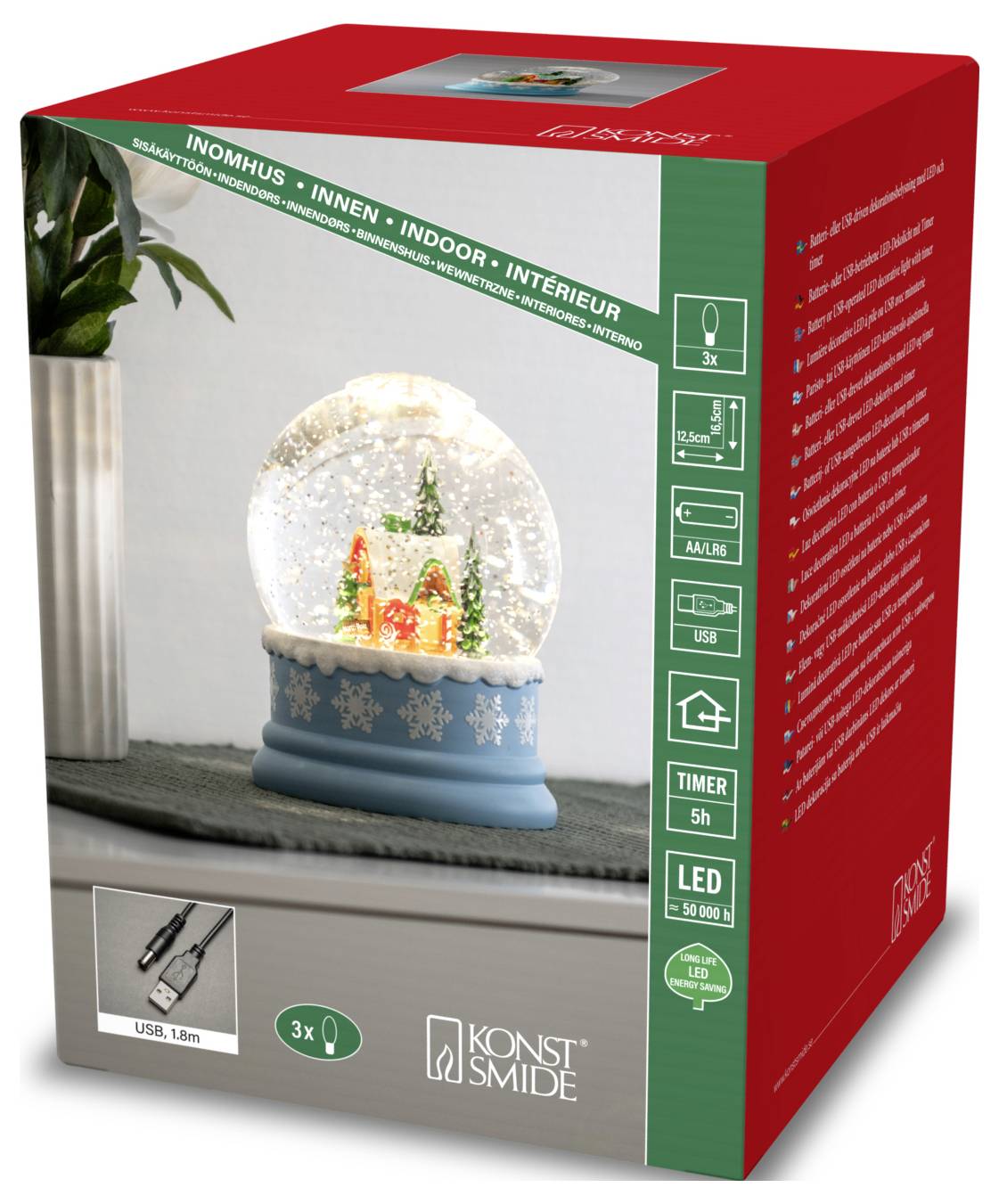 The image shows a red box packaging for a Konst Smide LED snow globe with timer. The globe displays a snowy scene with trees and a house.