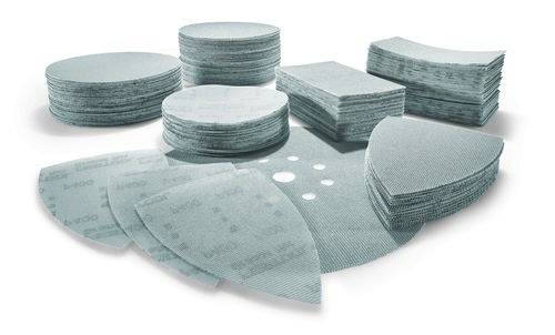 Variety of abrasive sanding discs and sheets in stacks, showcasing different shapes and sizes for diverse sanding applications.