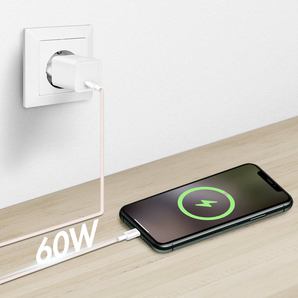 A phone charging on a table connected to a power outlet. A cable with '60W' text signifies fast charging. The phone screen shows a charging symbol.
