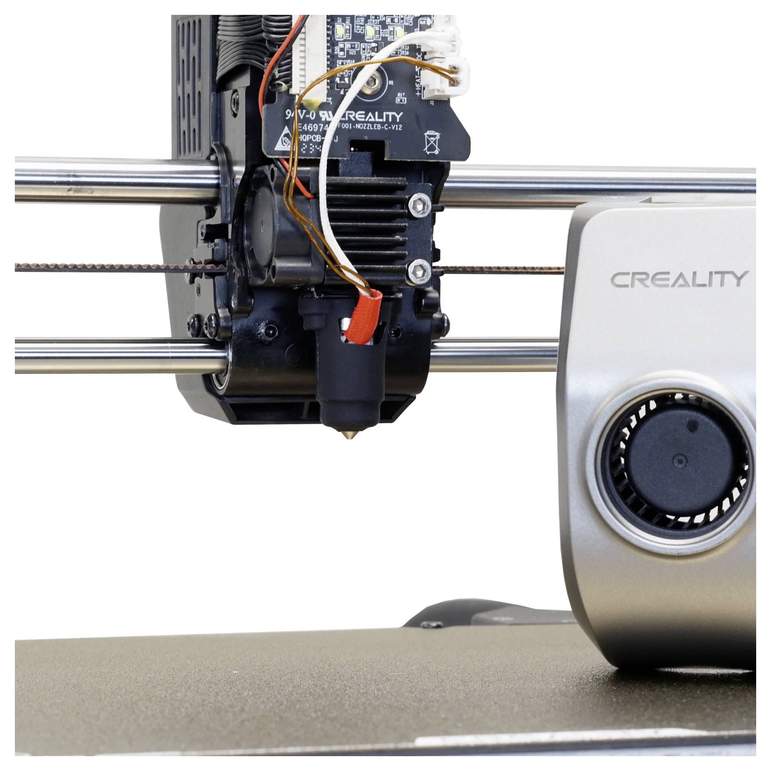 A 3D printer nozzle and extruder assembly in action, mounted on metal rods. The printer features the brand name Creality on a fan cover.
