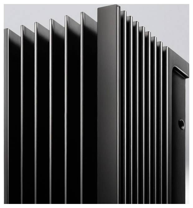 Close-up of a black metal heatsink with vertical fins, used for dissipating heat from electronic components.