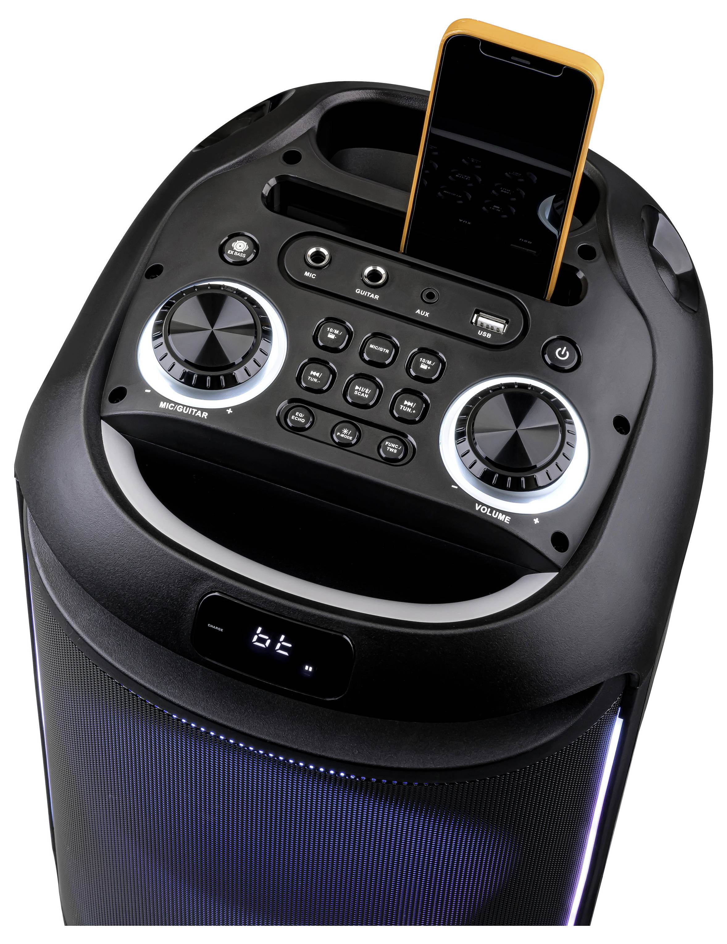 A black speaker with control panel featuring knobs, buttons, and a docked smartphone, likely for music playback and volume control.