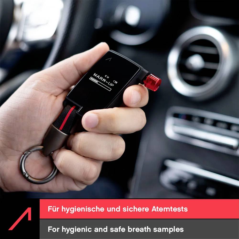 A hand holds a personal breathalyzer in a car interior, displaying the 'WARM-UP' message. Text reads 'For hygienic and safe breath samples.'