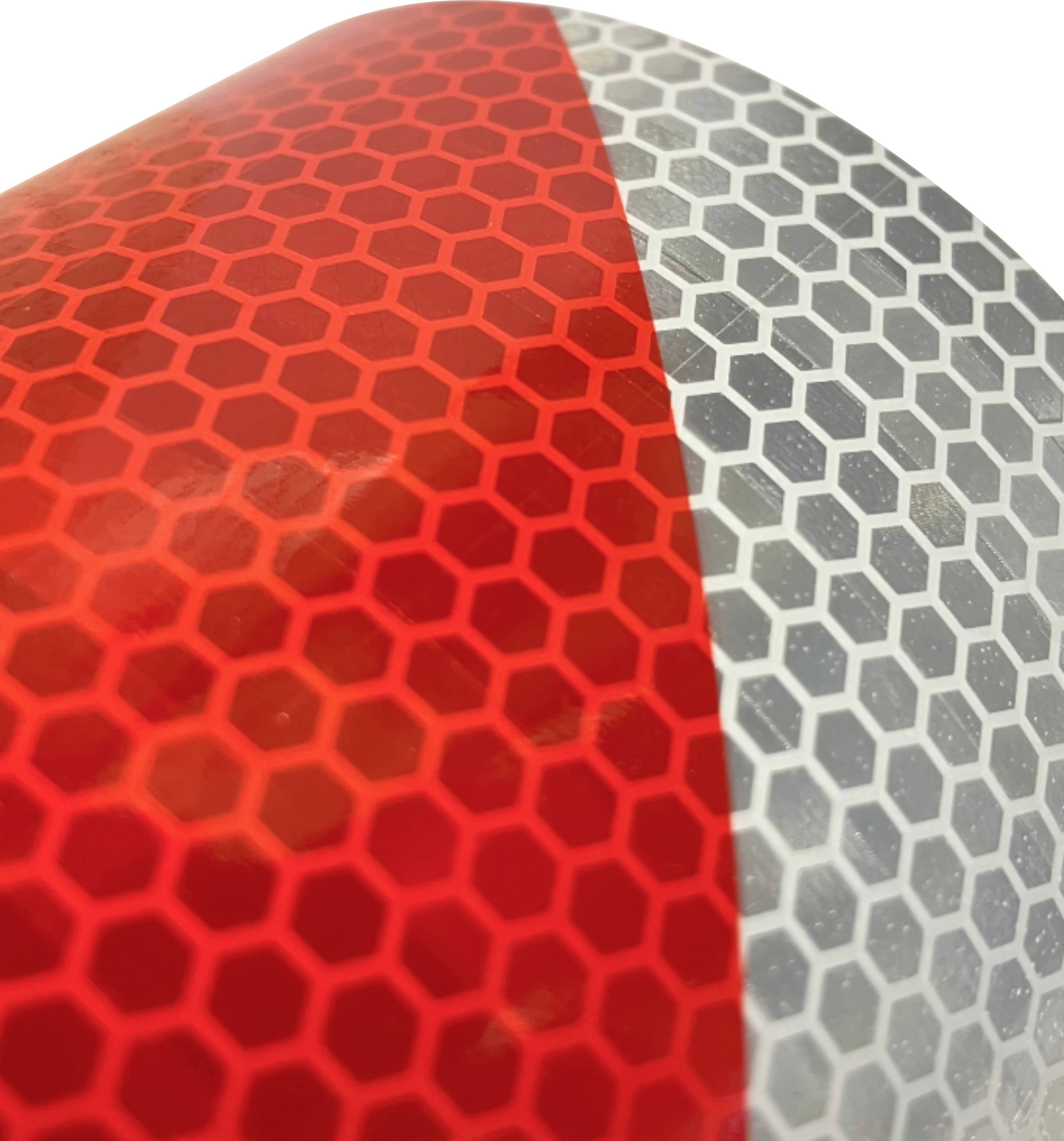Close-up of a reflective surface with red and gray hexagonal patterns.